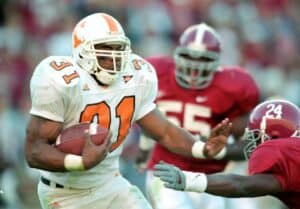 Jamal Lewis #31of the Tennessee Volunteers carries the ball as he blocks Tony Dixon #24 of the Alabama Crimson Tide at the Bryant Denny Stadium in Tuscaloosa, Alabama. The Voulunteers defeated the Crimson Tide 21-7.